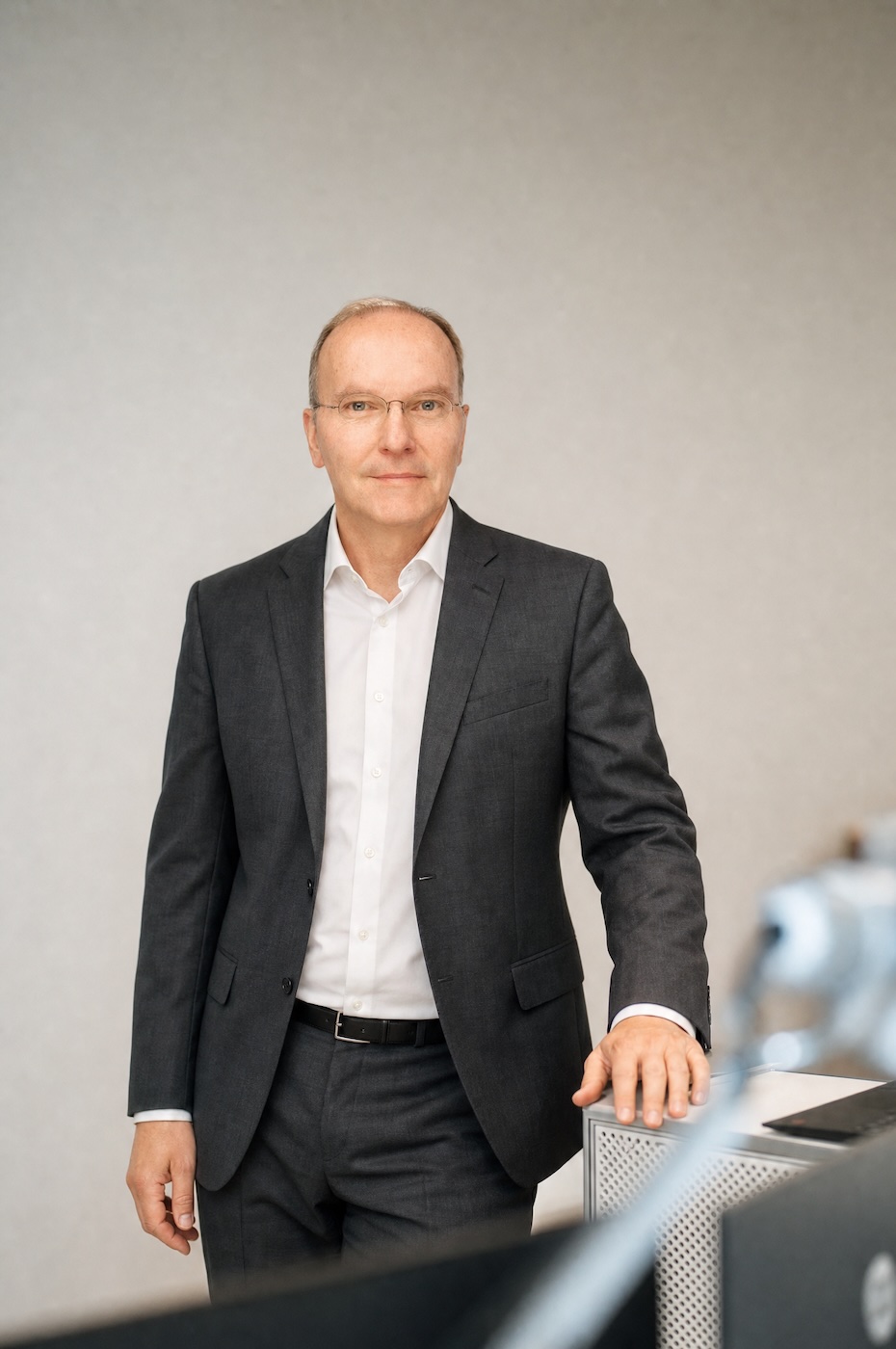 Peter Crul in a dark jacket and white shirt against a light background